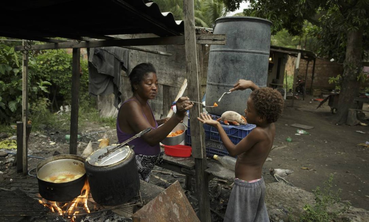 Com o alto preço do gás, Simone, de 49 anos, é obrigada a retroceder à lenha para cozinhar no quintal de casa Foto: Márcia Foletto / Agência O Globo