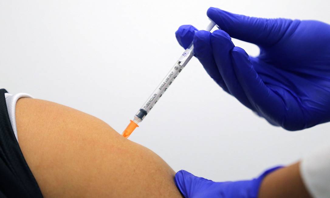 Mulher recebe dose da vacina da Pfizer contra Covid-19 na Austrália Foto: STEVEN SAPHORE / AFP