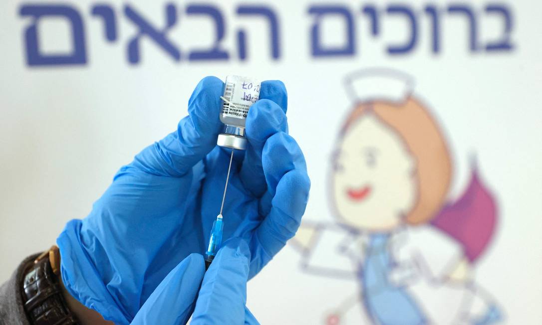 Profissional de saúde de Israel administra dose da vacina da Pfizer-BioNtech; Estado judeu está na dianteira da imunização contra a Covid-19 no mundo Foto: JACK GUEZ / AFP