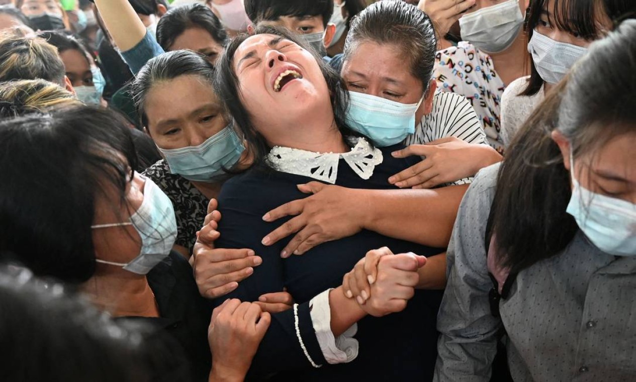 A mãe de Khant Nyar Hein é acodida por amigos no funeral do filho, em Yangon. O estudante de medicina de 17 anos foi morto pela polícia enquanto protestava contra o golpe militar em Mianmar Foto: STR / AFP
