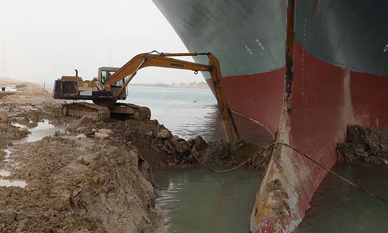 Escavadeira foi usada para liberar bulbo do navio, que atingiu a margem do Canal de Suez Foto: - / AFP