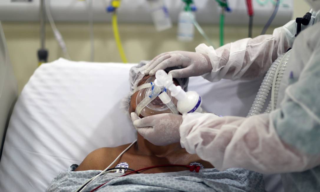 Fisioterapeuta ajusta máscara de oxigênio em paciente com Covid-19, em São Paulo Foto: AMANDA PEROBELLI / REUTERS