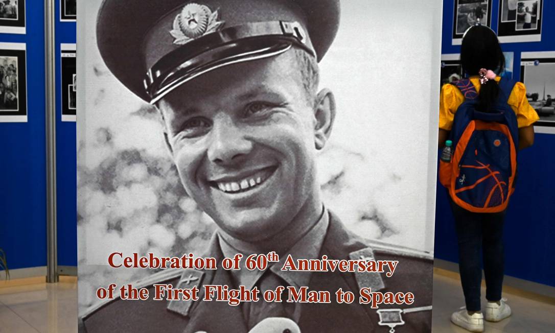 Estudante olha as fotos do cosmonauta russo Yuri Gagarin durante uma exposição organizada para comemorar o 60º aniversário do primeiro voo do homem ao espaço, em Calcutá, 12 de abril de 2021 Foto: DIBYANGSHU SARKAR / AFP