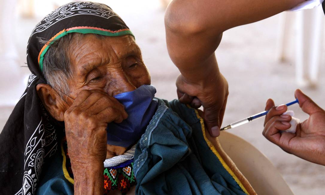 Indígena Wixarica é imunizada com a vacina CanSino Biologics contra COVID-19 no centro de vacinação instalado na cidade de Nuevo Colonia, em Mezquitic, estado de Jalisco, México Foto: ULISES RUIZ / AFP