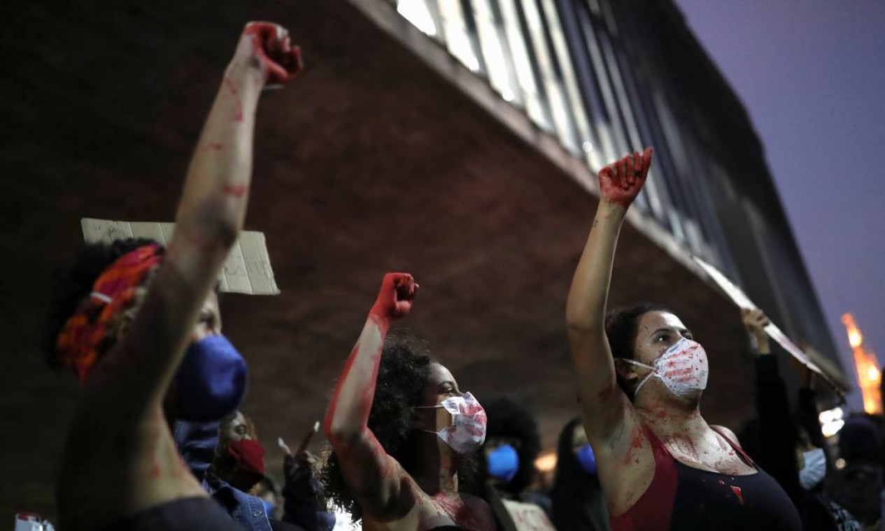 Em São Paulo, manifestantes erguem os punhos com as mãos pintadas de vermelho Foto: AMANDA PEROBELLI / REUTERS