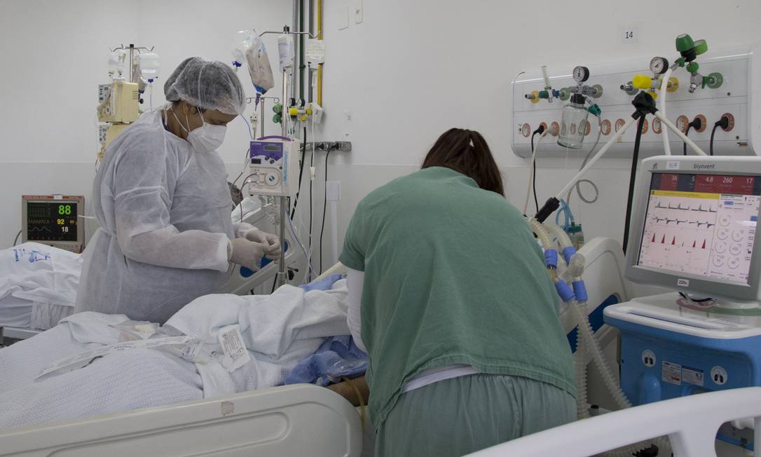 Profissionais de saúde atendem paciente no Hospital de Campanha da Zona Norte, em São Paulo Foto: ASI - Mister Shadow / Agência O Globo