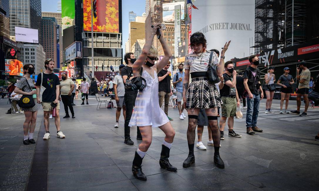 La gente balla a Times Square a Manhattan, New York City, mentre le restrizioni imposte per combattere la facilità di Covid-19.  Foto: Ed Jones/AFP