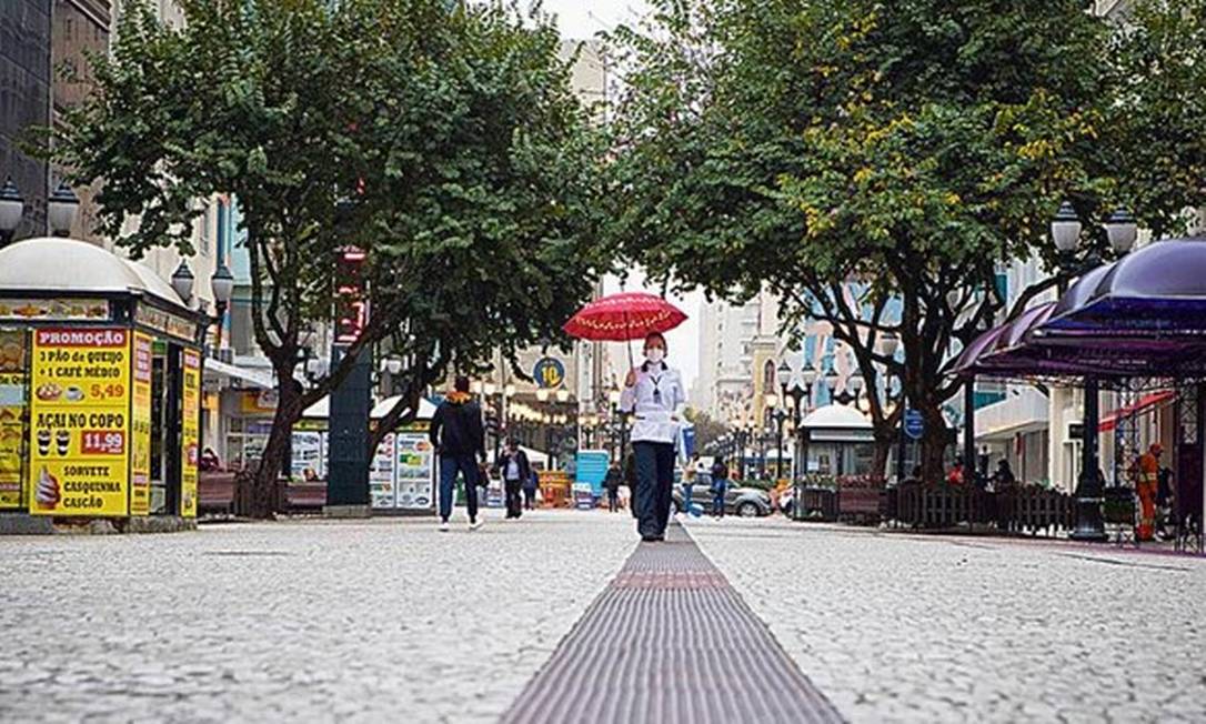 Pedestres no Centro de Curitiba: apenas serviços essenciais estão abertos no município Foto: Guilherme Pupo