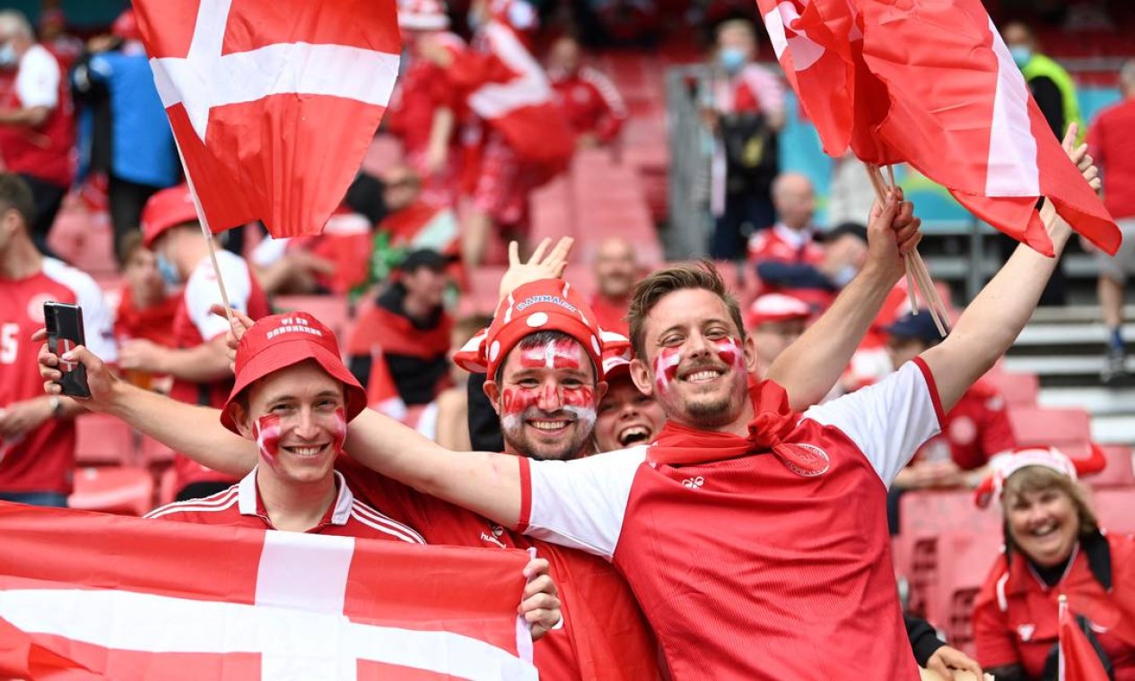 Torcedores da Dinamarca festejam antes do jogo de futebol do Grupo B contra Finlândia, no Estádio Parken, em Copenhague, Foto: JONATHAN NACKSTRAND / AFP