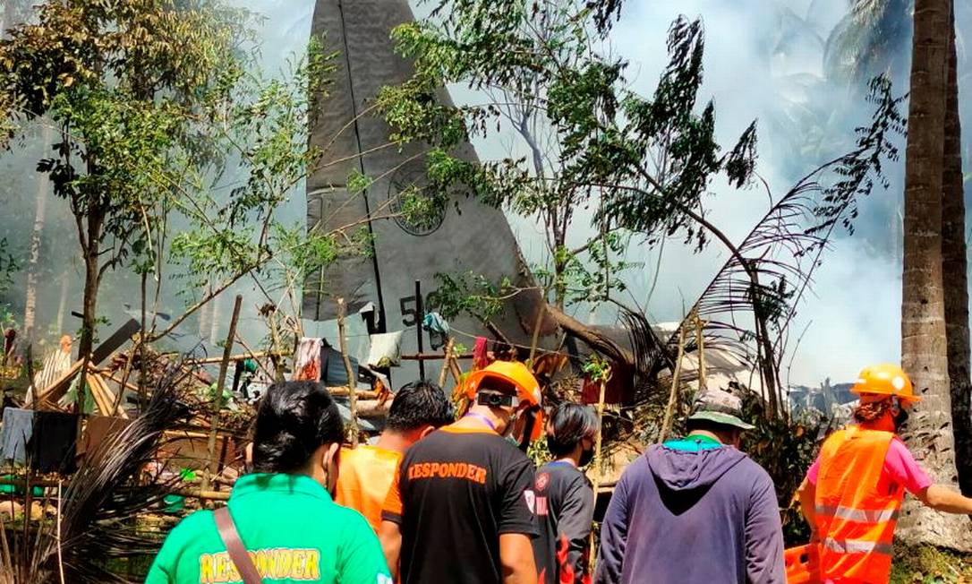 Equipe de resgate chegam ao local da queda da aeronave Lockheed C-130, que caiu ao tentar pousar na ilha de Joló, nas Filipinas Foto: PHILIPPINES ARMY JFT SULU / via REUTERS