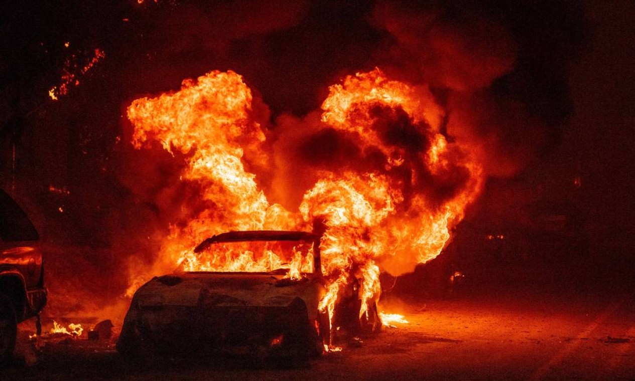 Um carro em chamas é visto no bairro no bairro de Indian Falls, no condado de Plumas Foto: JOSH EDELSON / AFP
