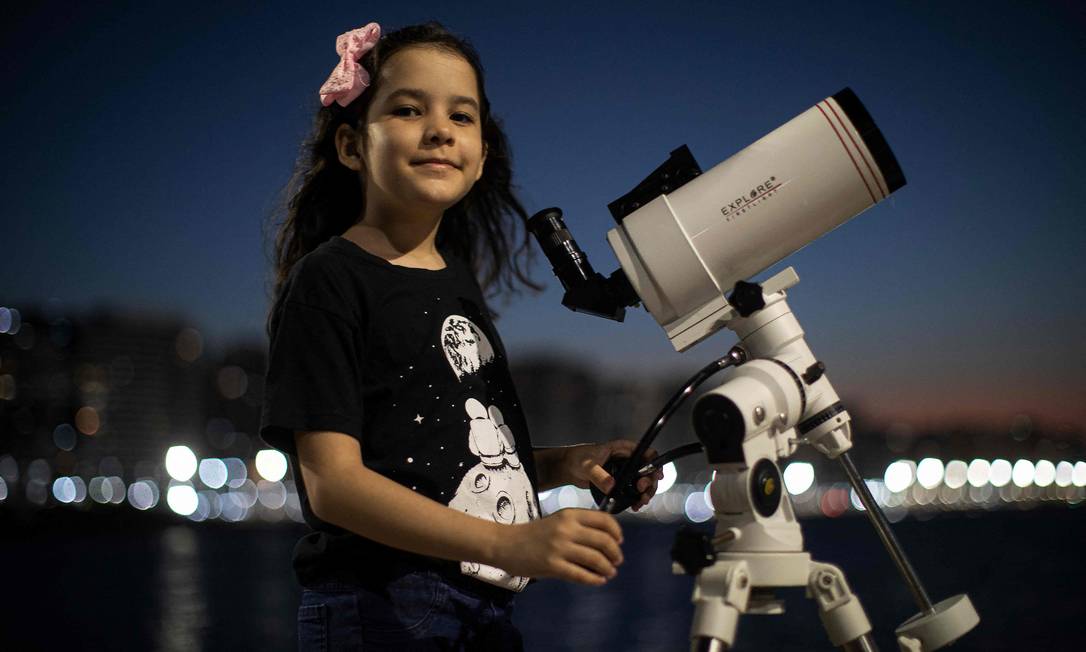 A astr�noma brasileira Nicole Oliveira, de 8 anos, posa para uma foto com seu telesc�pio em Fortaleza Foto: JARBAS OLIVEIRA / AFP
