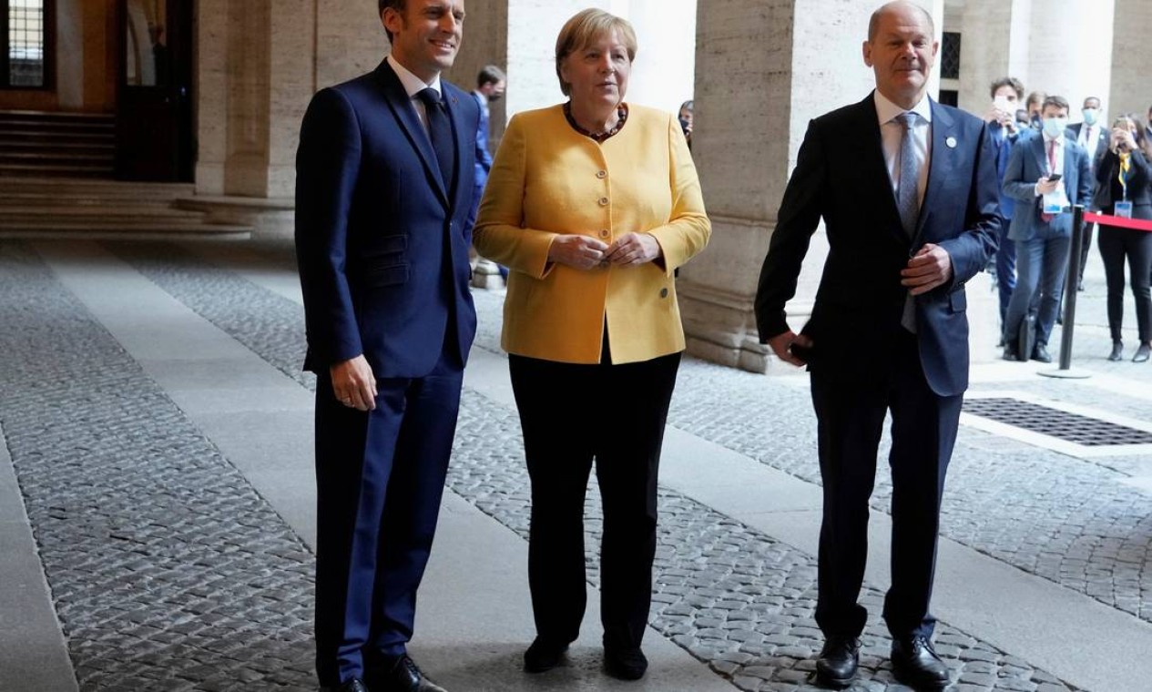 Macron com a chanceler alemã, Angela Merkel, e o ministro alemão das Finanças, Olaf Scholz, antes de uma reunião da União Europeia e da União Africana na Embaixada da França em Roma Foto: POOL / REUTERS