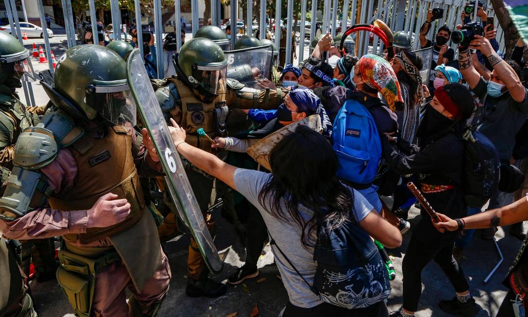 Povo indígena Mapuche chileno e seus apoiadores enfrentam tropas de choque durante protesto contra o governo do Chile em frente ao prédio do Congresso em Valparaíso, Chile. Um indígena Mapuche morreu e cinco outros ficaram feridos na quarta-feira durante confrontos com o policiais Foto: DEDVI MISSENE / AFP