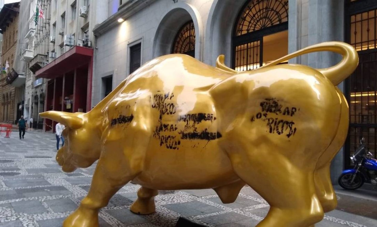 É o segundo dia seguido que o touro de ouro instalado em frente à sede da B3, a Bolsa de Valores Brasileira, foi alvo de algum tipo de intervenção de movimentos sociais Foto: Reprodução / Twitter