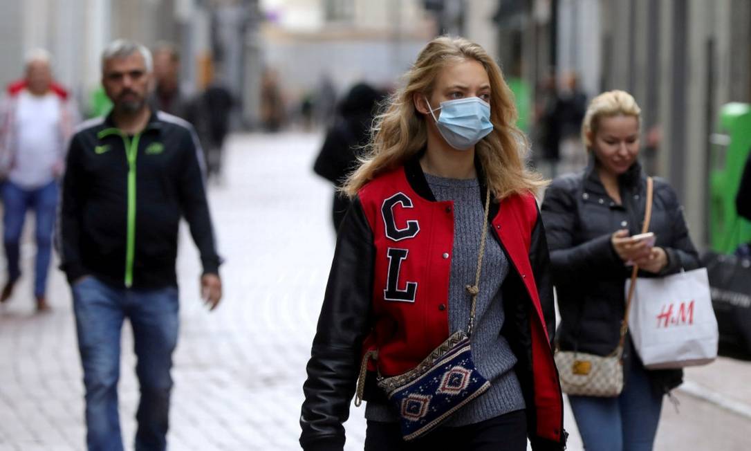 Com máscara e sem, pessoas caminham pela rua em Amsterdam Foto: EVA PLEVIER / REUTERS/7-10-2020