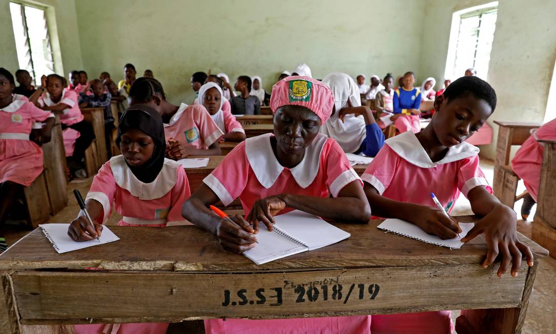 MARÇO - Shade Ajayi pisou pela primeira vez em uma escola neste ano, para aprender a ler e escrever ao 50 anos, na Ilorin, estado de Kwara, na Nigéria Foto: TEMILADE ADELAJA / REUTERS