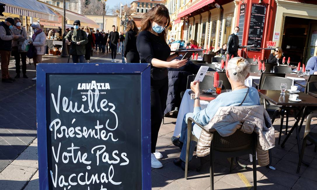 Funcionária de café em Paris checa certificado de vacinação de cliente; França deixou de aceitar teste negativo para entrada em locais públicos e transportes de média e longa distância Foto: Eric Gaillard / Reuters
