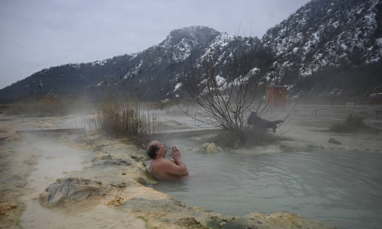 Homem desfruta de águas quentes em uma fonte mineral natural perto da vila de Rupite, província de Blagoevgrad, Bulgária Foto: NIKOLAY DOYCHINOV / AFP