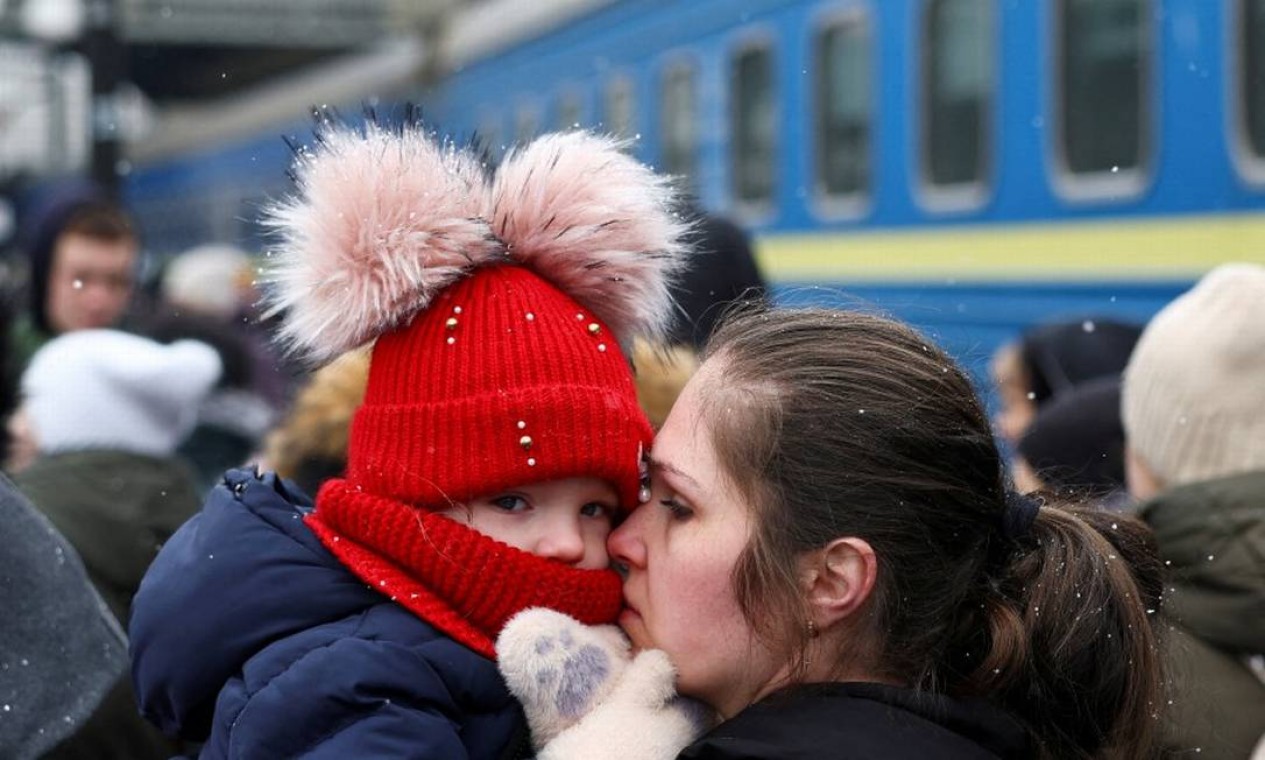 Pessoas esperam para embarcar em um trem em direção à Polônia enquanto fogem da invasão russa à Ucrânia, na estação de trem em Lviv Foto: KAI PFAFFENBACH / REUTERS