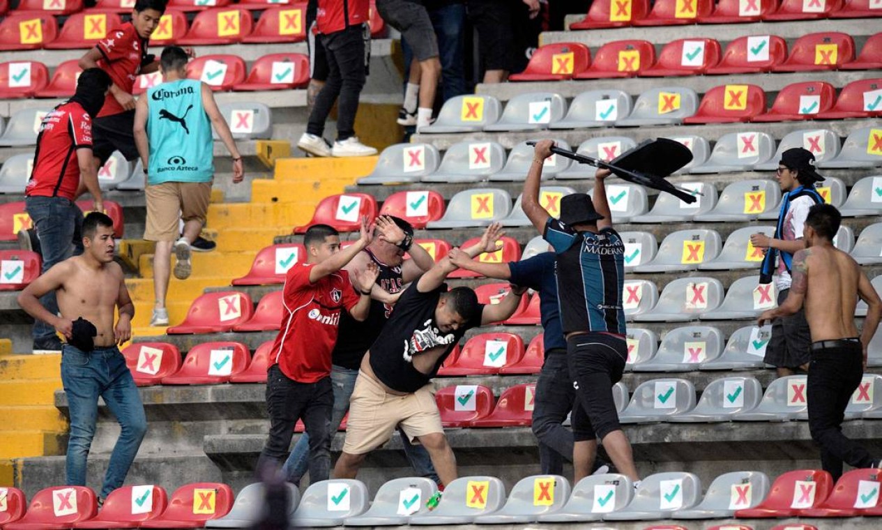 Torcedores se enfrentam nas arquibancadas do estádio: o jogo entre Querétaro e Atlas, pela Liga Mexicana, foi suspenso Foto: STR / AFP