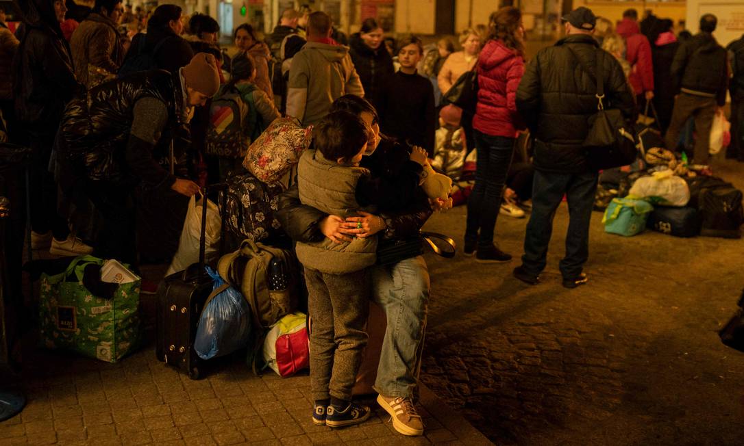 Fuga do horror: refugiados ucranianos esperam ônibus em frente à estação ferroviária de Przemysl, na Polônia Foto: ANGELOS TZORTZINIS / AFP/23-03-2022