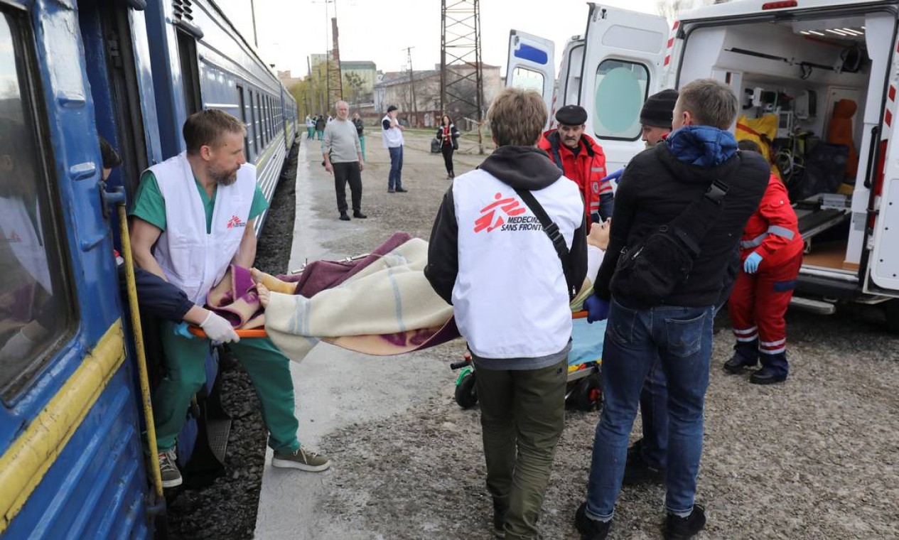 Trabalhadores médicos ajudam pessoas evacuadas e feridas que chegam de trem especial de Bakhmut e Slovyansk para tratamento, em meio à invasão russa da Ucrânia, em Lviv Foto: ROMAN BALUK / REUTERS
