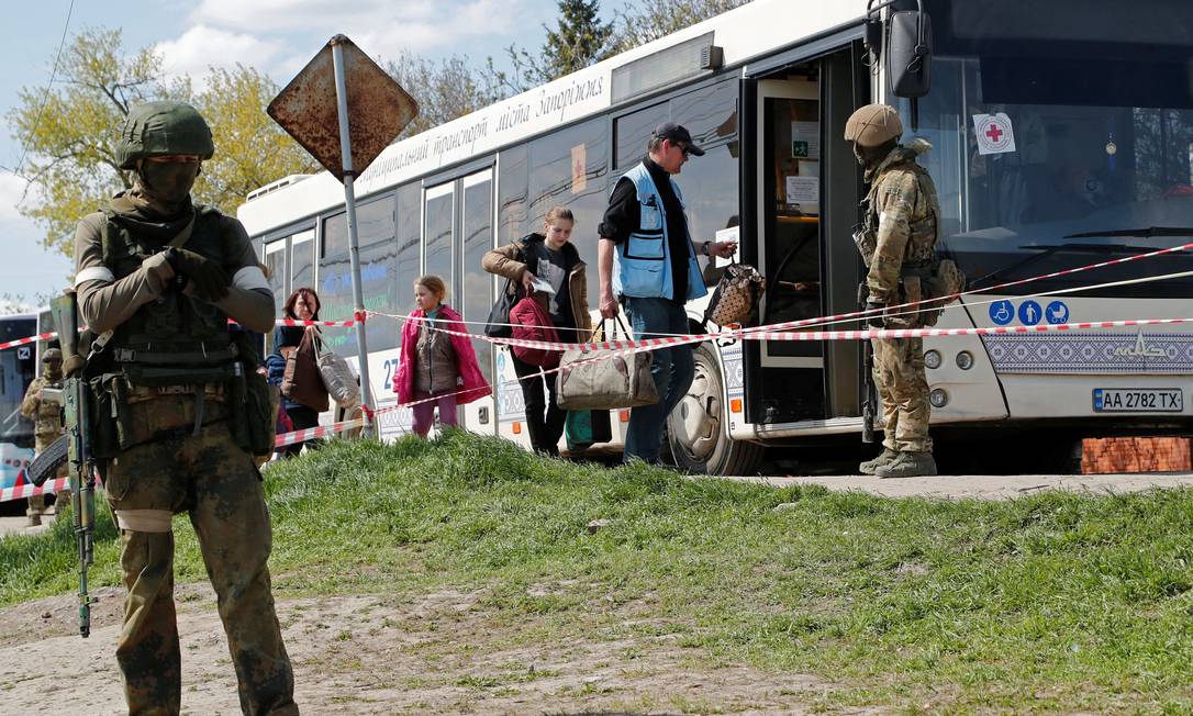 Civis que deixaram a área perto da usina siderúrgica de Azovstal, em Mariupol, embarcam em um ônibus acompanhado por um funcionário da ONU Foto: ALEXANDER ERMOCHENKO / REUTERS