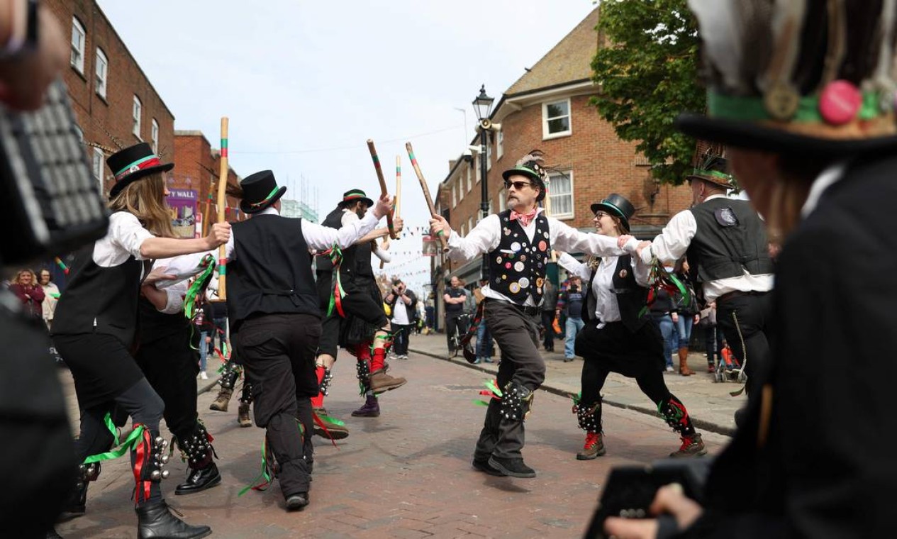 Pessoas participam do Rochester Sweeps Festival, celebração de música e dança folclórica que se tornou uma das maiores celebrações do Dia do Trabalhador em Rochester, sudeste de Londres Foto: ADRIAN DENNIS / AFP
