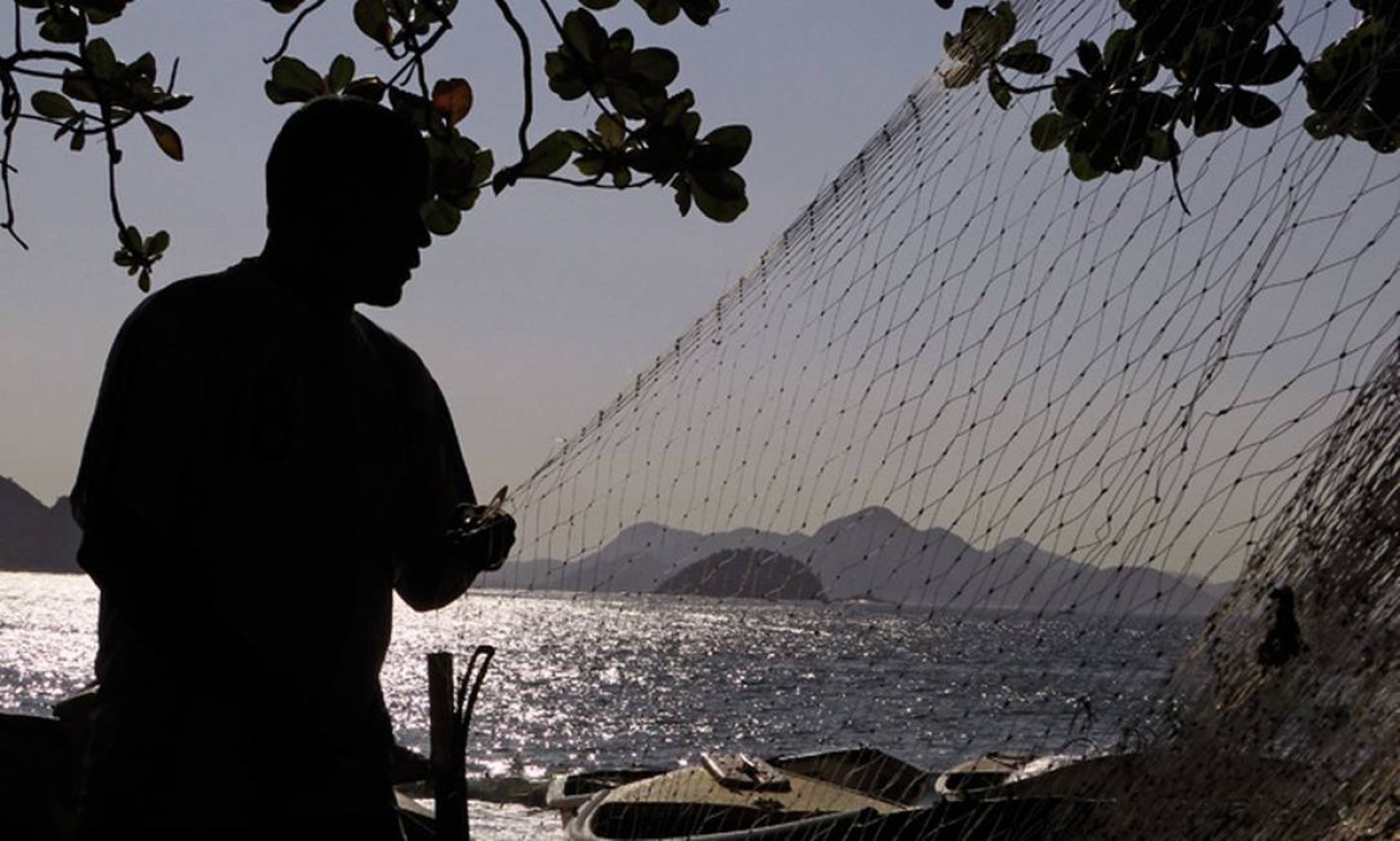 Pescador desenrola sua rede no Posto 6, em Copacabana Foto: Eu-repórter / Leitor José Conde