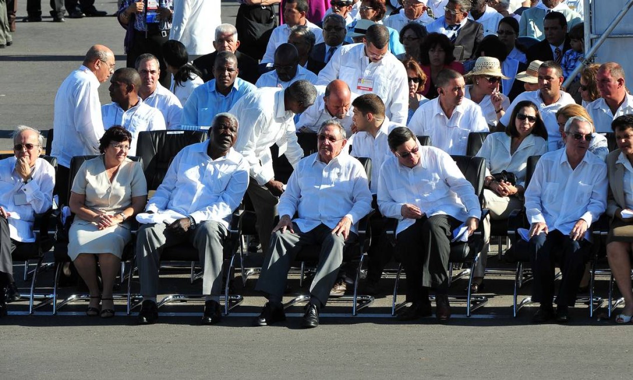 Raúl Castro, ao centro, e outros membros do governo assistem à missa na primeira fila Foto: AFP