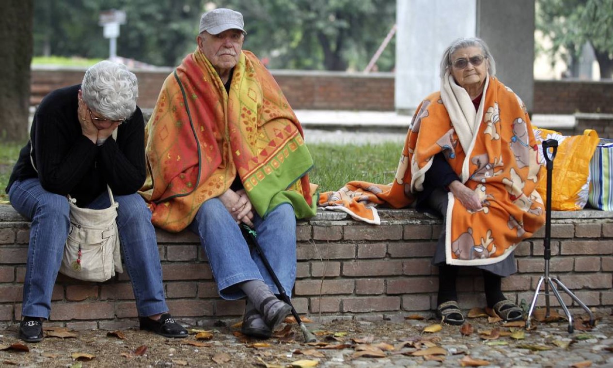 Pessoas sentadas na rua após o terremoto que antingiu o norte do país Foto: Giorgio Benvenuti / REUTERS