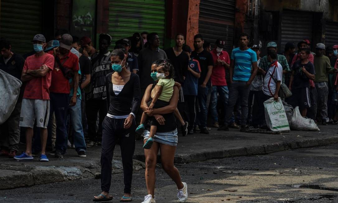 População em condição de rua aguarda para receber alimentos em Medellin Foto: JOAQUIN SARMIENTO / AFP