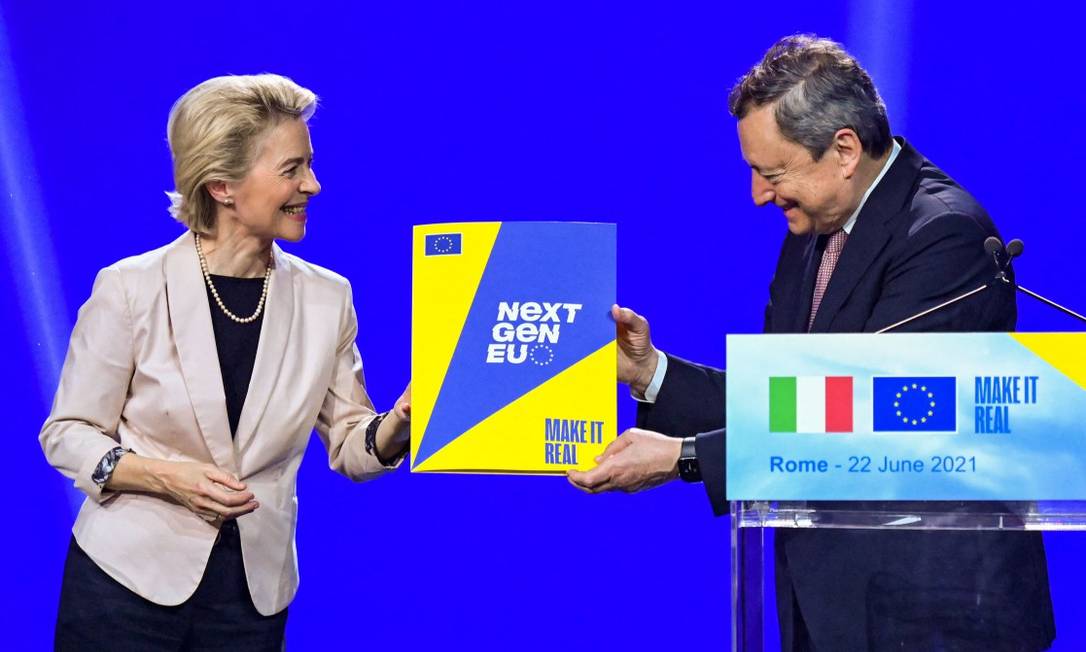 A presidente da Comissão Europeia, Ursula von der Leyen, simbolicamente entrega ao premier italiano Mario Draghi o plano de recuperação da UE Foto: ALBERTO PIZZOLI / AFP