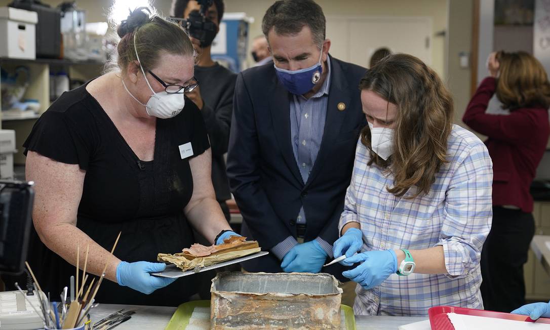 Governor Ralph Nordham, Center, sees Virginia's Chief Guardian of the Department of Historical Resources, Kate Ridgeway, left, and Sue Donovan, University of Virginia Special Collection Defender, right, remove the time capsule contents.  : Steve Helper / AB